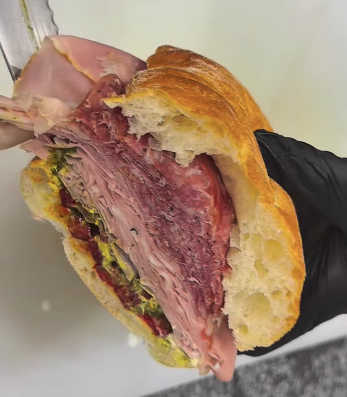 Close-up of a loaded DeliCut sandwich in crusty bread